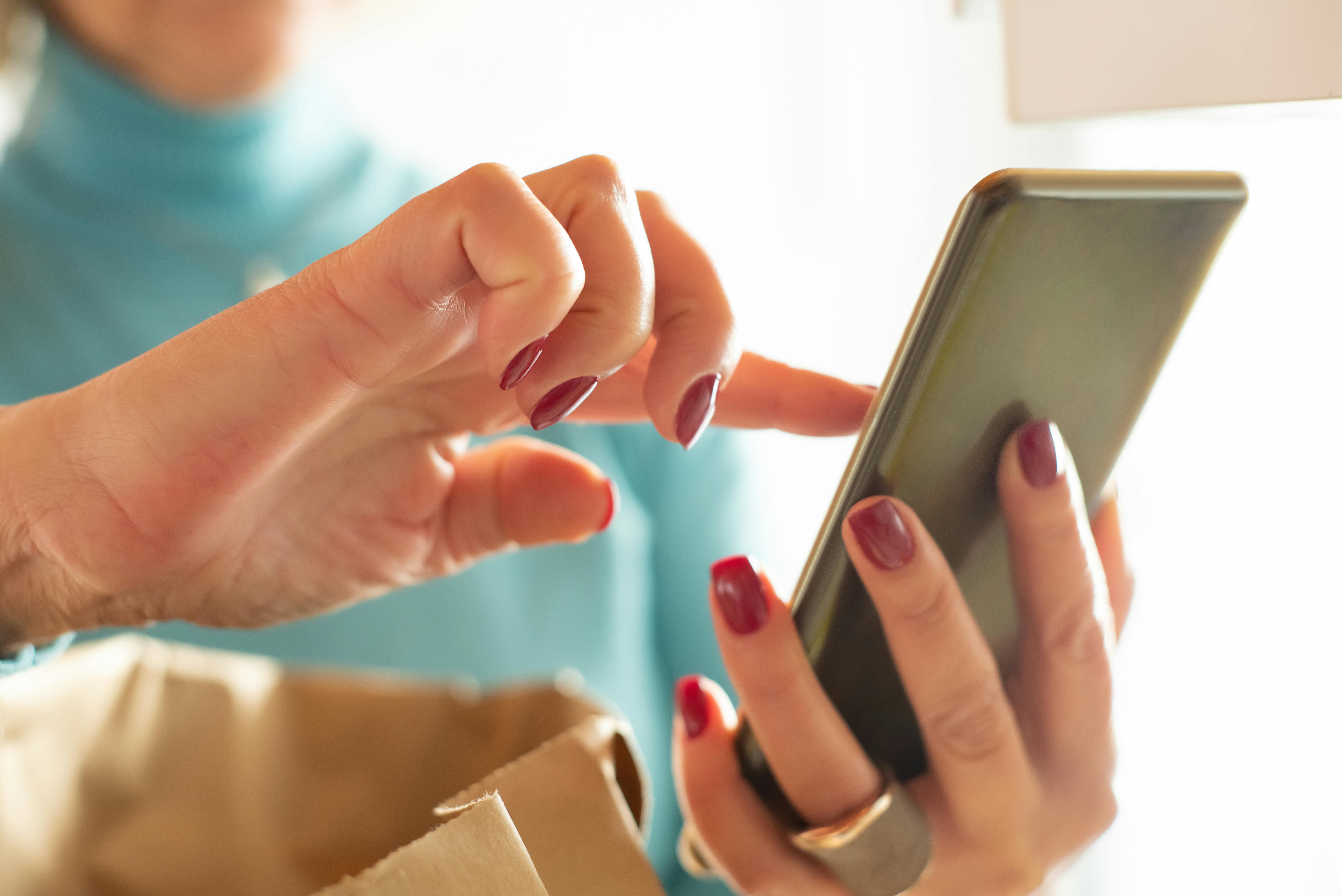 Kobieta trzymająca telefon w rękach | Źródło: Pexels